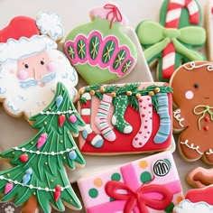 decorated christmas cookies with santa clause and stockings on them, all in different shapes and sizes