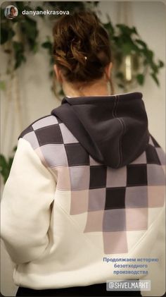 the back of a woman's sweatshirt with a checkered pattern on it,