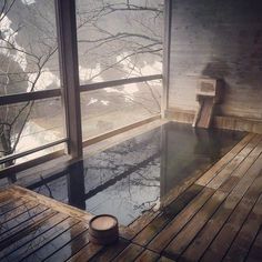 an indoor hot tub in the middle of a wooden deck