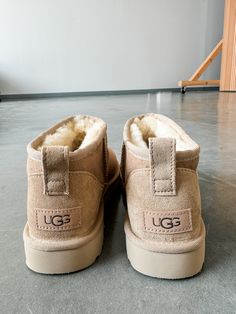 DESCRIPTION: The Classic Ultra Mini updates UGG's most iconic silhouette with a lower shaft height, adding easy on-off and enhanced versatility. Pre-treated to keep it looking better for longer, this classic features everything you love about the original signature UGG sheepskin and a flexible, lightweight sole. Wear with virtually anything – the styling options are endless. SIZE & FIT: True to size. If in-between, size down. 3.5" shaft height MATERIAL & CARE: Sheepskin/lyocell insole Ugg Ultra Mini Sand, Uggs Ultra Mini Sand, Cute Fall Shoes, Ugh Mini Boots Outfit, Ugg Sand, Uggs Ultra Mini, Ultra Mini Uggs, Cute Uggs, Ugg Ultra Mini