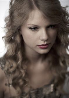 a beautiful young woman with long curly hair