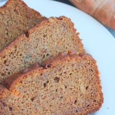 three slices of bread on a white plate with carrots in the backgroud