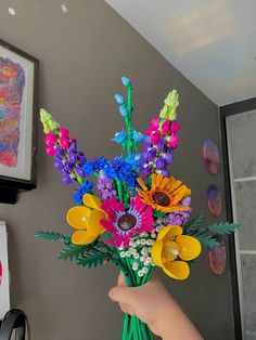 a person holding a bouquet of colorful flowers