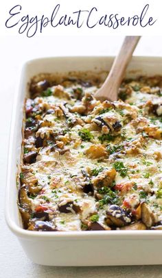 an eggplant casserole in a white dish with a wooden spoon