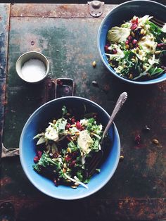 two blue bowls filled with food next to each other