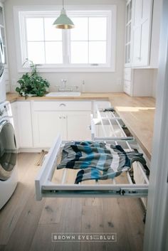 a kitchen with a washer and dryer in it