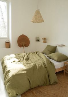 a bed sitting in a bedroom next to a window