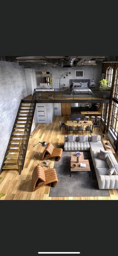 an aerial view of a living room and kitchen with stairs leading up to the second floor