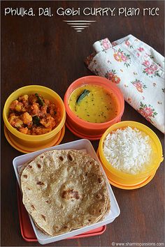 some food is sitting on a table with rice and other foods in bowls next to it