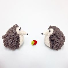 two hedges made out of yarn with an apple