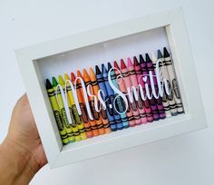 a person holding up a box of crayons with the words miss smith written on them