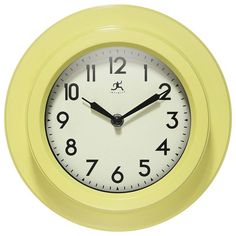 a yellow wall clock with black hands and numbers