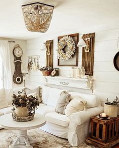 a living room filled with white furniture and lots of decor on top of carpeted flooring