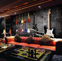 a living room filled with lots of furniture and guitars on the wall above it's glass coffee table