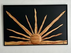 a painting on a wall with sticks in the shape of a sun