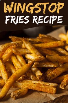 a pile of french fries sitting on top of a wooden cutting board with the words wingstop fries recipe