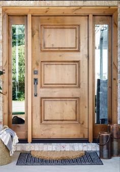 the front door is made from wood and has two sidelights on each side, one with