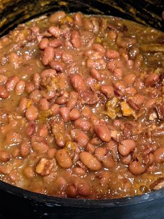 a pot filled with beans sitting on top of a stove