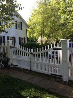 a white picket fence in front of a house