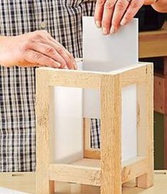 a man is making a model with wood blocks