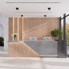 an office lobby with marble counter tops and wood paneling on the walls, along with potted plants