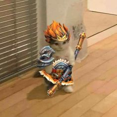 a white cat with an orange and blue flame on it's head holding two swords