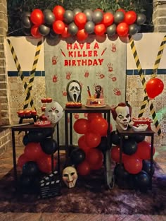 a birthday party with balloons and decorations on the table in front of a sign that says have a killer birthday