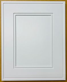 a white square frame on a yellow wall