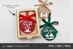 two christmas ornament in a box with ribbon