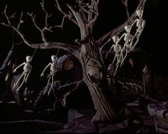 halloween decorations in the shape of skeletons hanging from trees