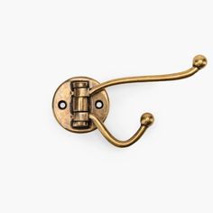 an antique brass hook on a white background