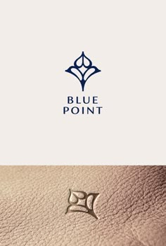 the logo for blue point is shown on top of a brown leather surface and below it,