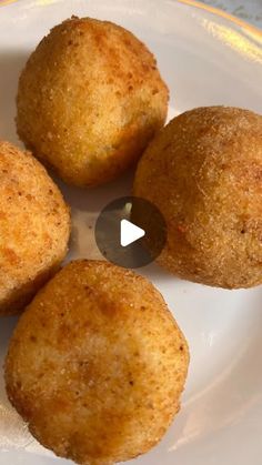 four fried food items on a plate with a video play button in the middle to see what they are