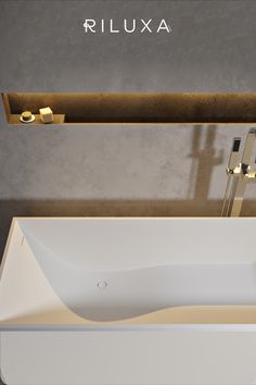 a white sink sitting on top of a counter next to a faucet mounted above it