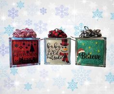 three christmas gift boxes with bows on them and snowflakes in the back ground