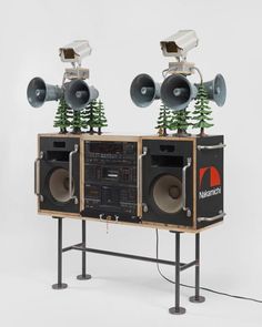 two speakers with trees on top of them