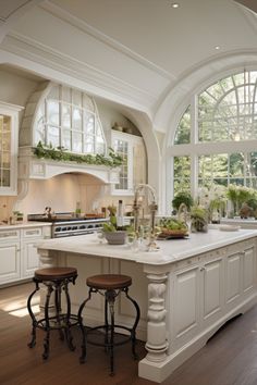 a large kitchen with an island in the middle and two stools next to it