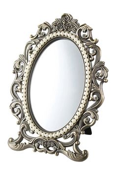 an ornate mirror with pearls on it