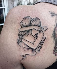 the back of a woman's shoulder with tattoos on it