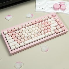 a pink computer keyboard sitting on top of a desk