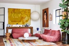 a living room filled with furniture and art