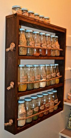 a shelf filled with lots of jars next to a wall