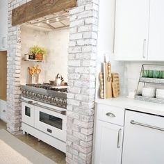 a kitchen with an oven, stove and counter top in it's center area