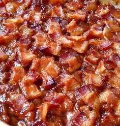 a casserole dish with meat and sauce in it sitting on a table top