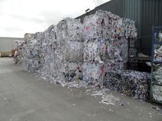 a large pile of garbage sitting next to a building