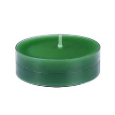 a green candle sitting inside of a metal container