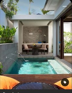 an indoor swimming pool in the middle of a patio