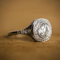 A rare antique engagement rings, surrounded by a halo of diamonds. Circa 1920. 1920 Engagement Ring, Estate Diamond Jewelry, Antique Engagement Ring, Antique Wedding Rings, Wedding Rings Halo, Antique Engagement, Deco Engagement Ring, Wedding Rings Unique, Wedding Rings Vintage