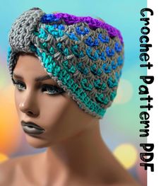 a mannequin head wearing a crocheted hat with blue and purple details