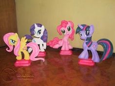 five little pony figurines lined up on the floor